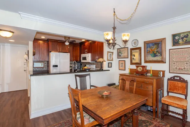 a view of a dining room with furniture and chandelier