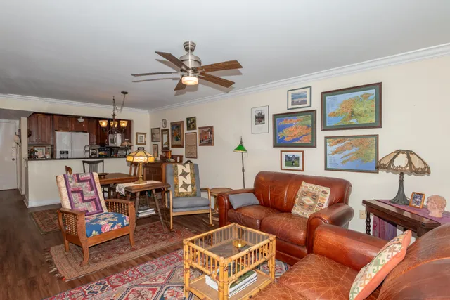 a living room with furniture a wooden floor and a window