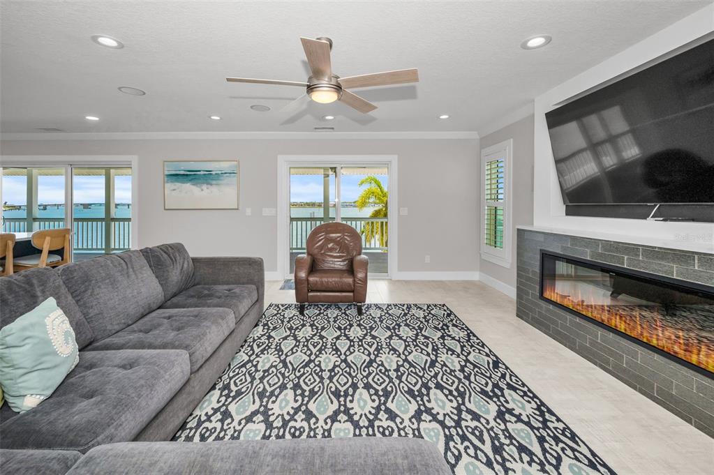 804 Bay Point Drive Madeira Beach, FL 33708 - Photo 20 of 100 a living room with furniture and a fireplace