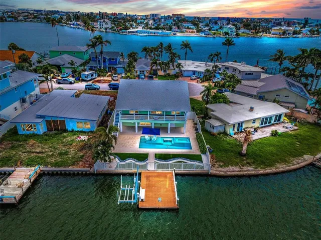an aerial view of a house with a lake view