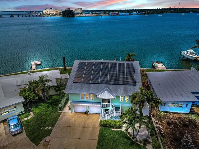 an aerial view of a house with a lake view