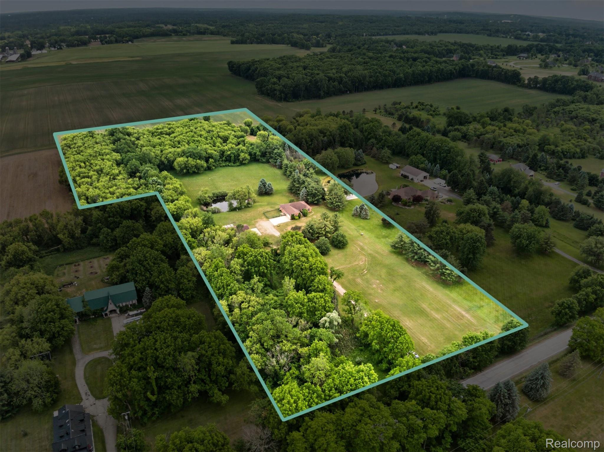 8558 37 Mile Road Romeo, MI 48065 - Photo 26 of 29 Expansive property featuring a single-story residence, mature trees, open green spaces, and a private pond