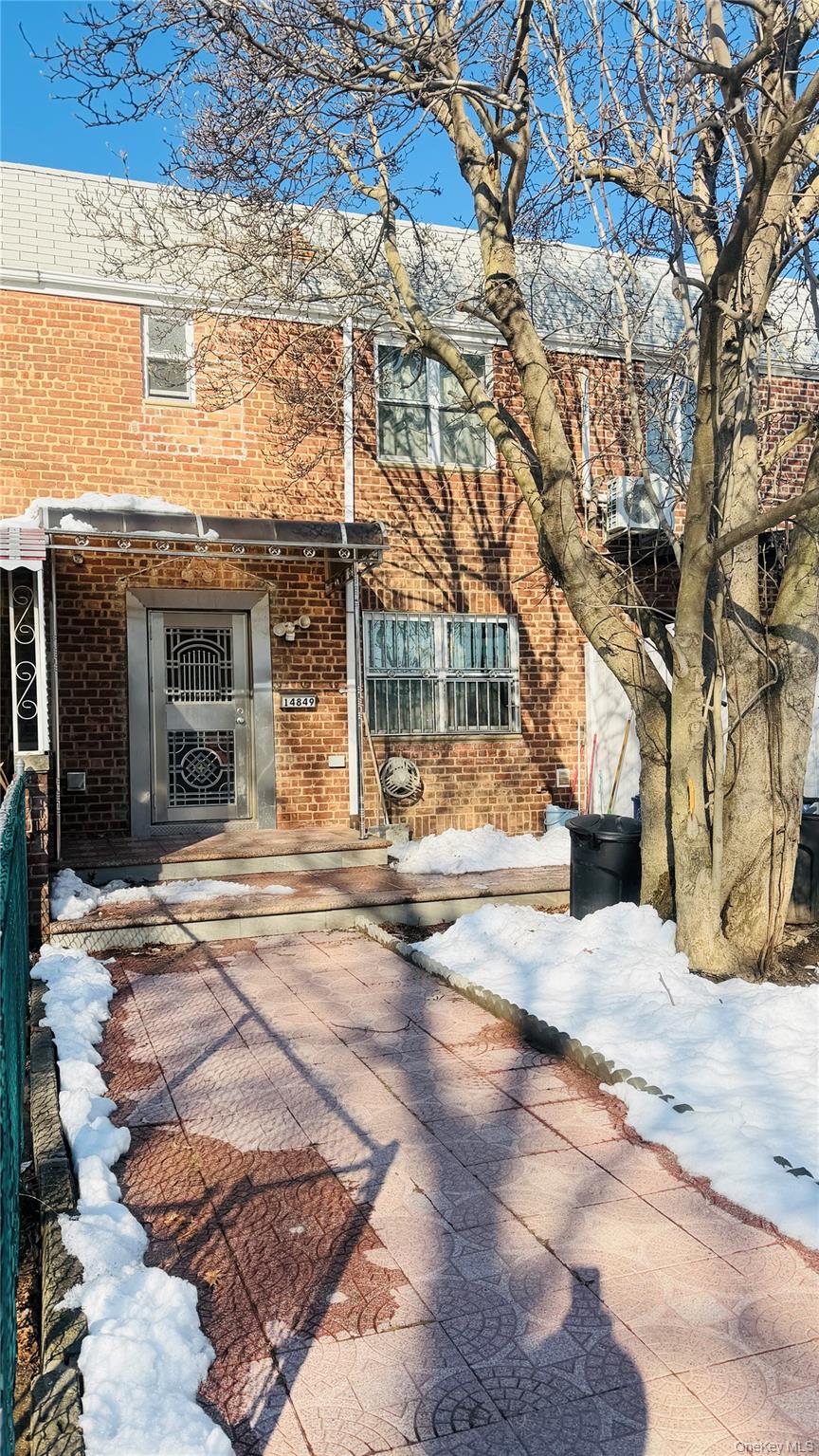 a view of white house with a tree in front of it