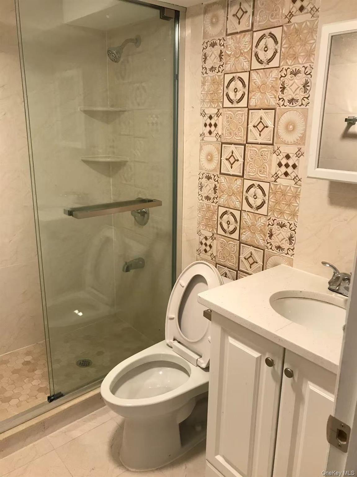 148-49 58th Road Queens, NY 11355 - Photo 5 of 10 a bathroom with a sink a toilet and shower