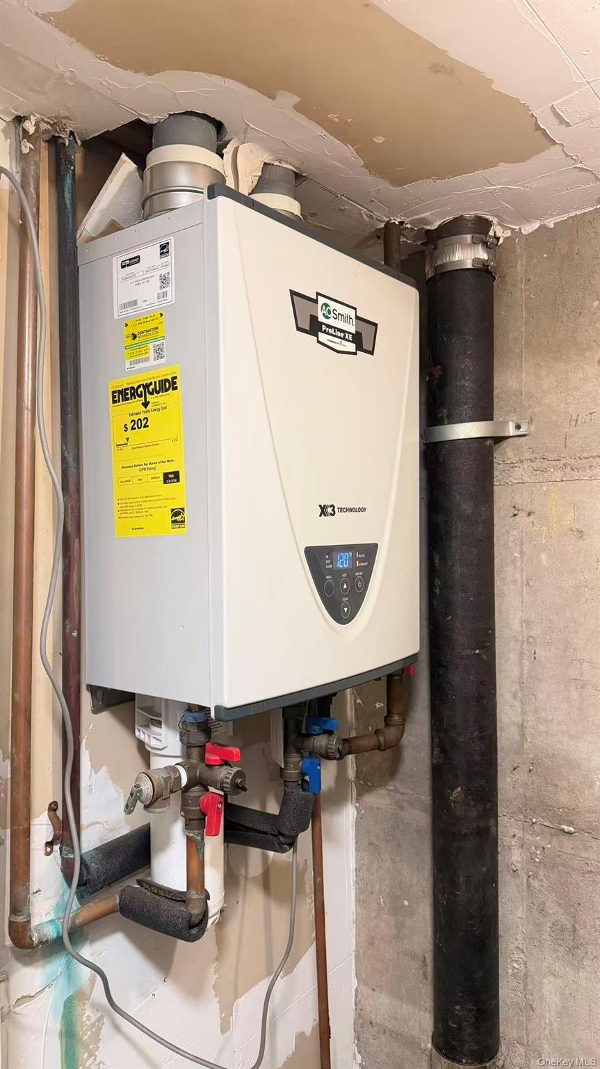 148-49 58th Road Queens, NY 11355 - Photo 8 of 10 a kitchen with a refrigerator and table