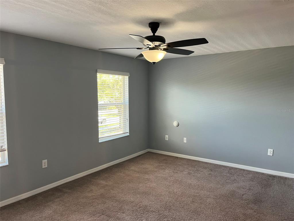 1242 Acadia Harbor Place Brandon, FL 33511 - Photo 13 of 28 an empty room with windows and fan