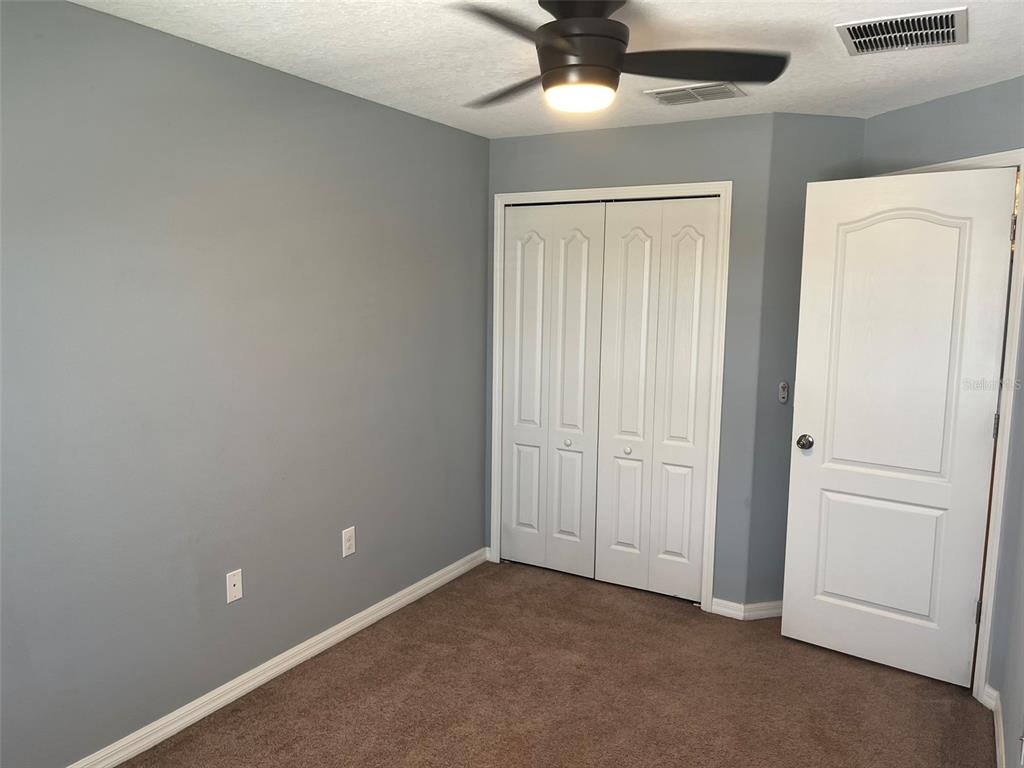 1242 Acadia Harbor Place Brandon, FL 33511 - Photo 14 of 28 an empty room with a ceiling fan and a window