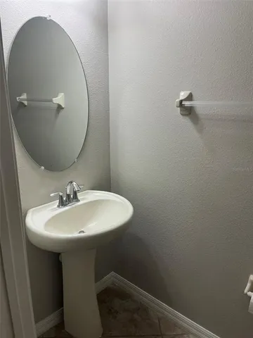 a bathroom with a sink a mirror and vanity