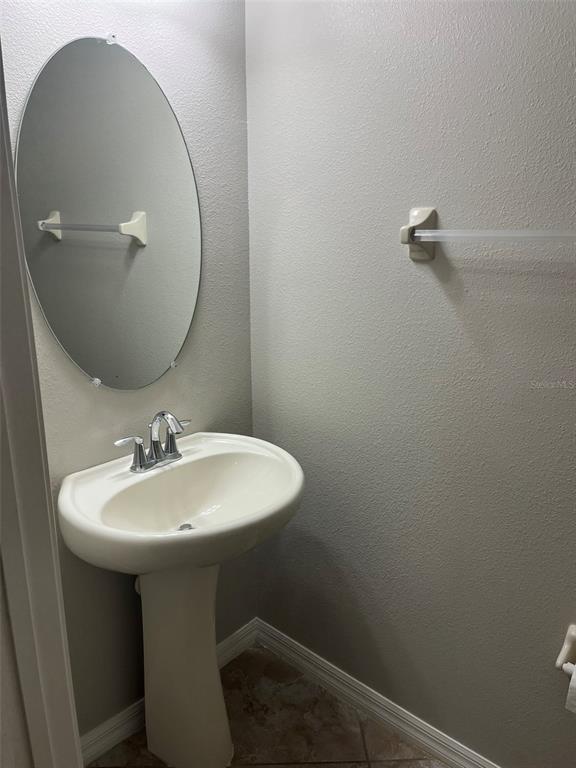 1242 Acadia Harbor Place Brandon, FL 33511 - Photo 21 of 28 a bathroom with a sink a mirror and vanity