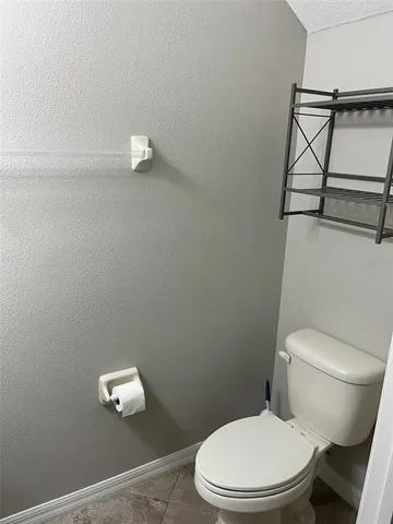 a white toilet sitting next to a bathroom sink