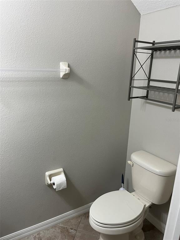 1242 Acadia Harbor Place Brandon, FL 33511 - Photo 22 of 28 a white toilet sitting next to a bathroom sink