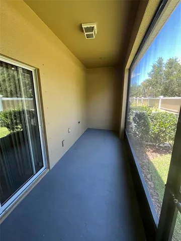a view of a porch with wooden floor and windows