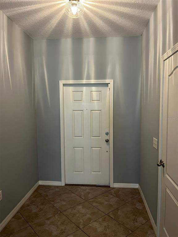 1242 Acadia Harbor Place Brandon, FL 33511 - Photo 7 of 28 an empty room with wooden door