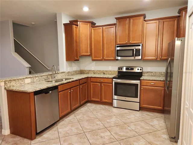 a kitchen with a sink stove and microwave