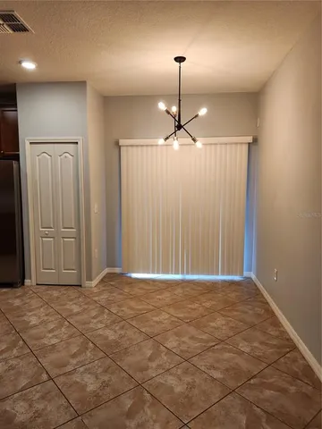 a view of an empty room with a mirror