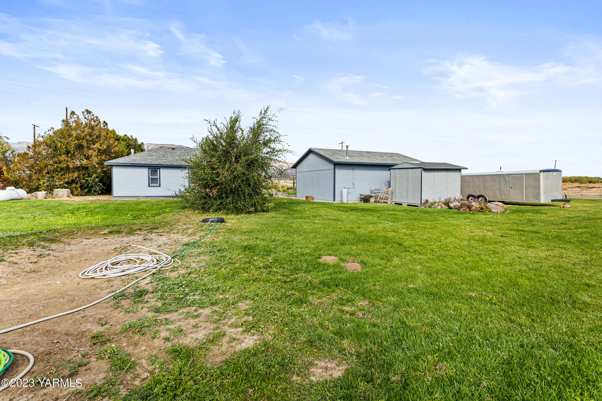 920 Dilley Road Tieton, WA 98947 - Photo 23 of 28 a view of a house with a yard and garage
