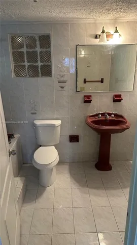 a bathroom with a toilet and a sink