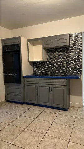 a kitchen with stainless steel appliances a sink and cabinets