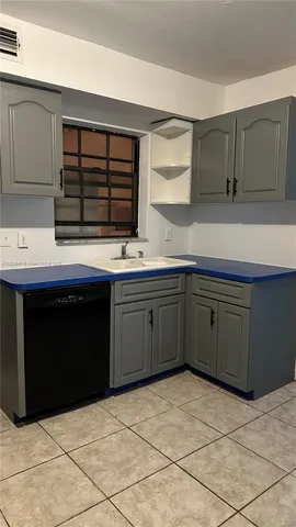 a kitchen with a cabinets and white appliances
