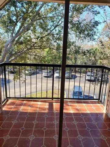 a view of balcony with a floor to ceiling window and wooden fence