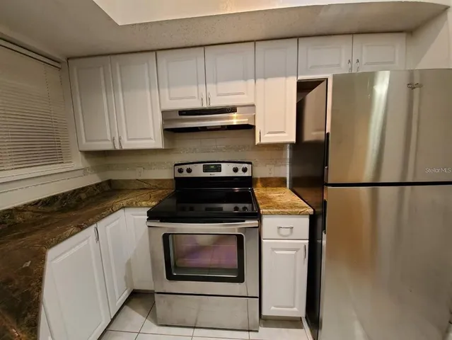 a kitchen with a stove microwave and refrigerator
