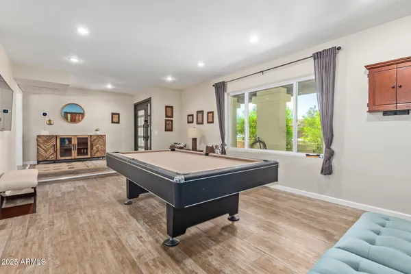 a bedroom with a large bed and a chandelier