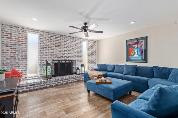 a living room with furniture a fireplace and a flat screen tv
