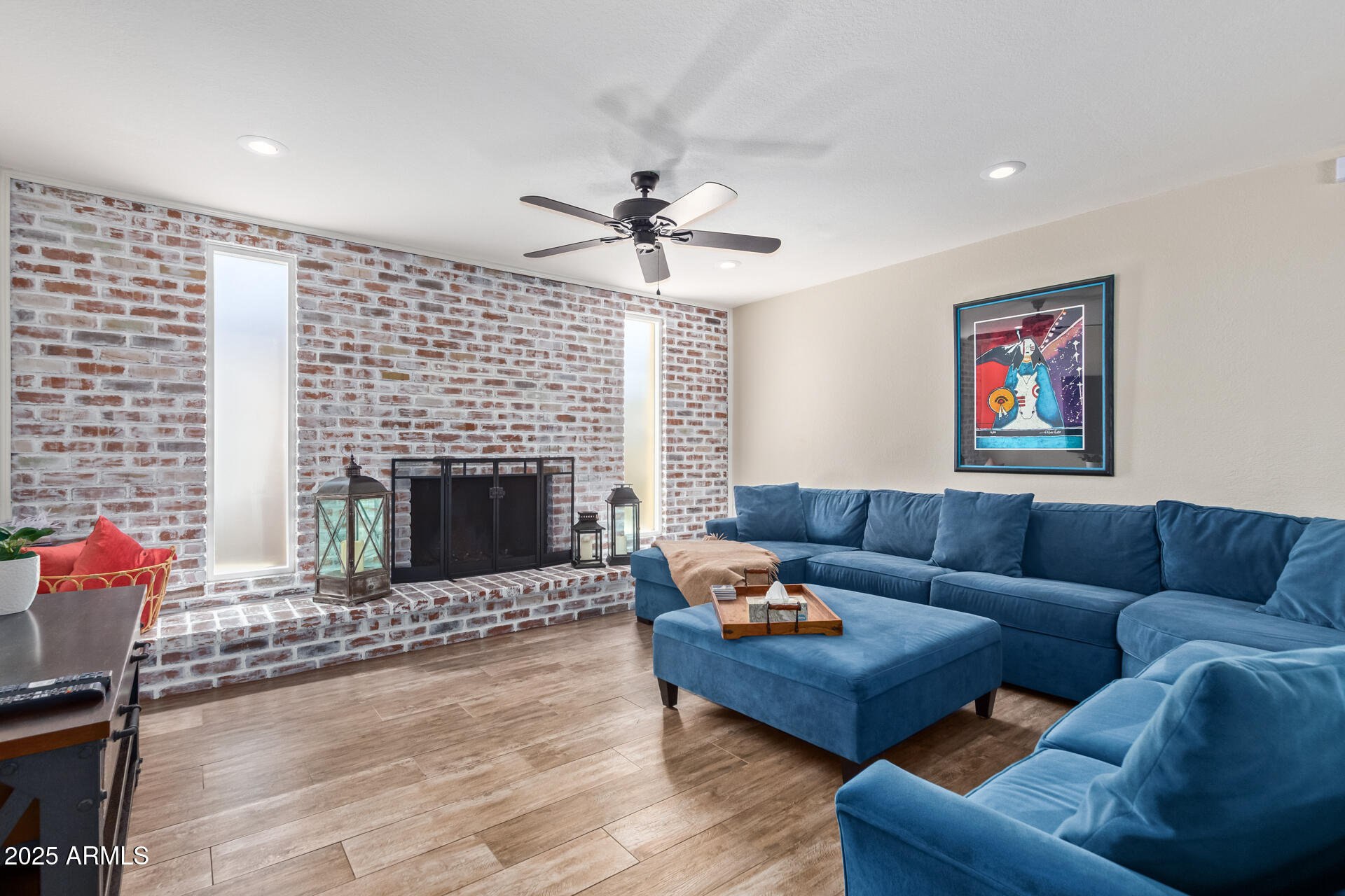 2118 East Pebble Beach Drive Tempe, AZ 85282 - Photo 7 of 33 a living room with furniture a fireplace and a flat screen tv