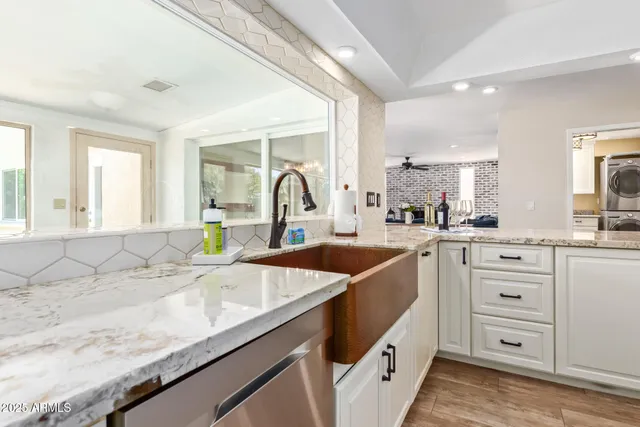 a kitchen with sink a stove and cabinets