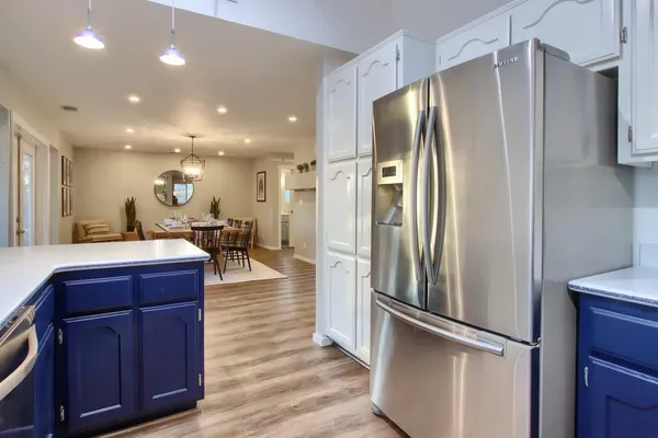 a kitchen with stainless steel appliances granite countertop a refrigerator and a sink
