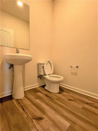 a bathroom with a sink toilet and a mirror