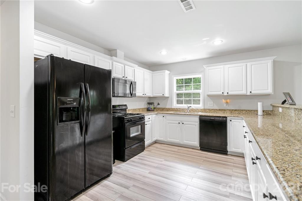 1174 South Rutherford Street Blacksburg, SC 29702 - Photo 17 of 40 a kitchen with granite countertop stainless steel appliances cabinets a sink and a window