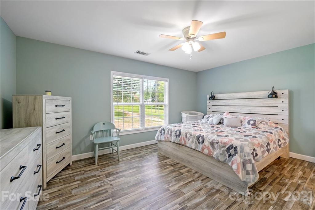 1174 South Rutherford Street Blacksburg, SC 29702 - Photo 19 of 40 a bedroom with a bed and a dresser
