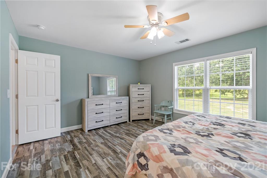1174 South Rutherford Street Blacksburg, SC 29702 - Photo 20 of 40 a bedroom with a bed and a chandelier