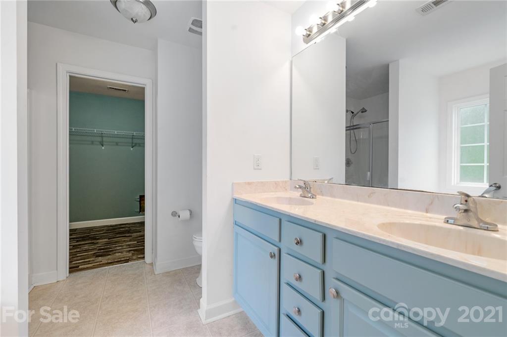 1174 South Rutherford Street Blacksburg, SC 29702 - Photo 21 of 40 a bathroom with a double vanity sink and a mirror