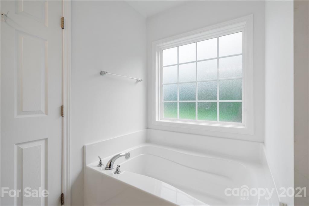 1174 South Rutherford Street Blacksburg, SC 29702 - Photo 23 of 40 a white bath tub sitting next to a window