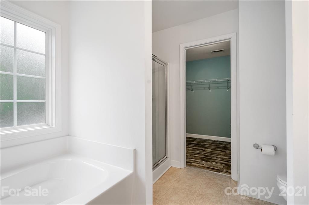 1174 South Rutherford Street Blacksburg, SC 29702 - Photo 24 of 40 a bathroom with a tub and shower