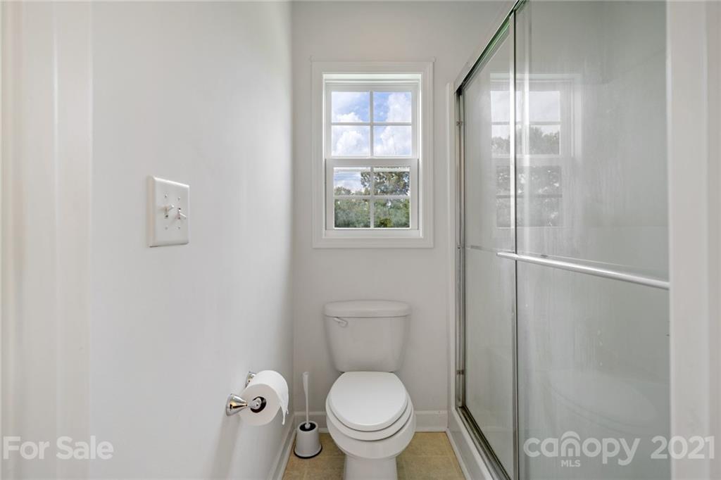1174 South Rutherford Street Blacksburg, SC 29702 - Photo 31 of 40 a white toilet sitting next to a bathroom sink