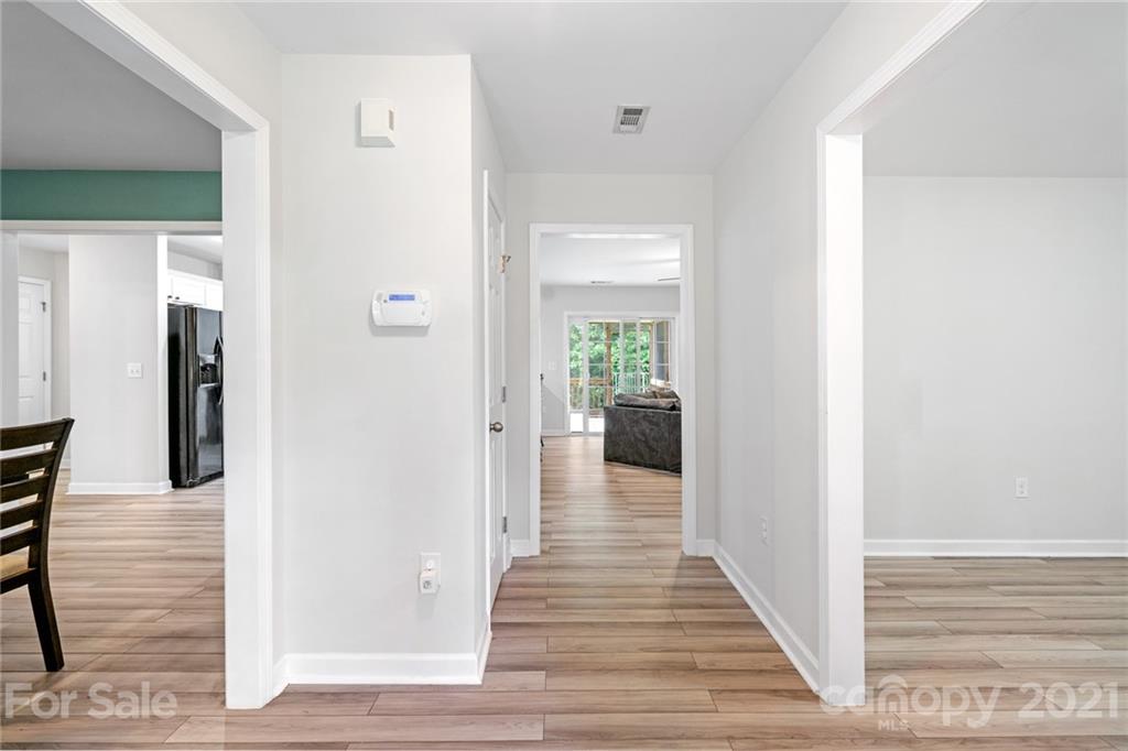 1174 South Rutherford Street Blacksburg, SC 29702 - Photo 6 of 40 a view of a hallway with wooden floor and a living room