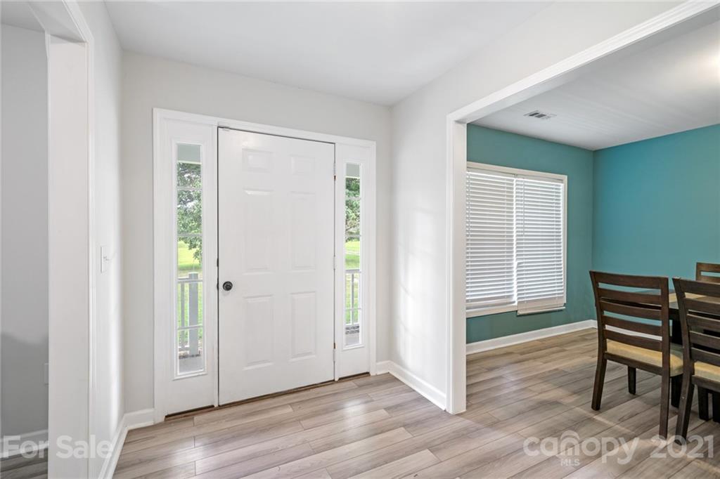 1174 South Rutherford Street Blacksburg, SC 29702 - Photo 7 of 40 a view of an empty room with wooden floor and a window