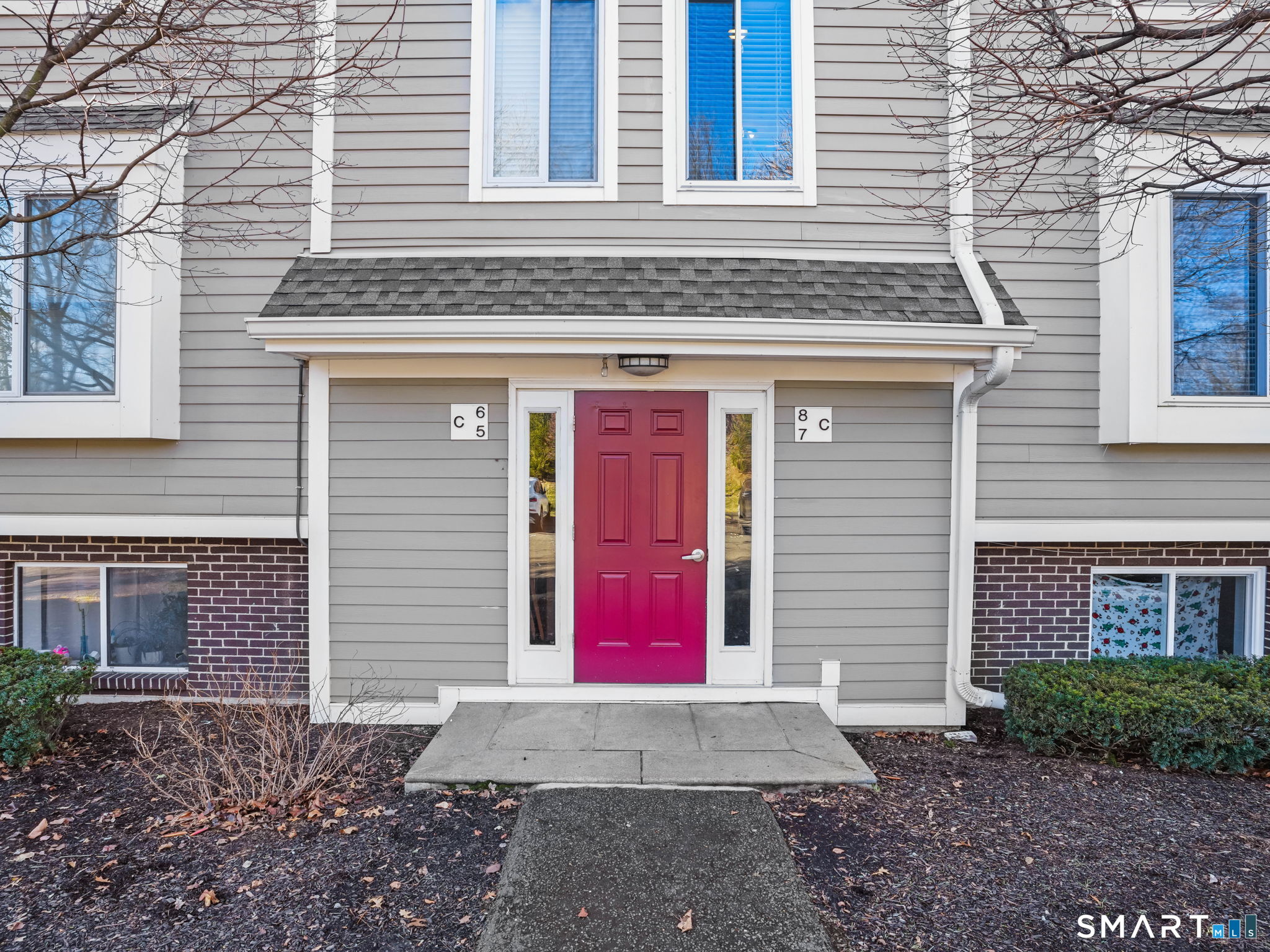 a view of a brick building with red door