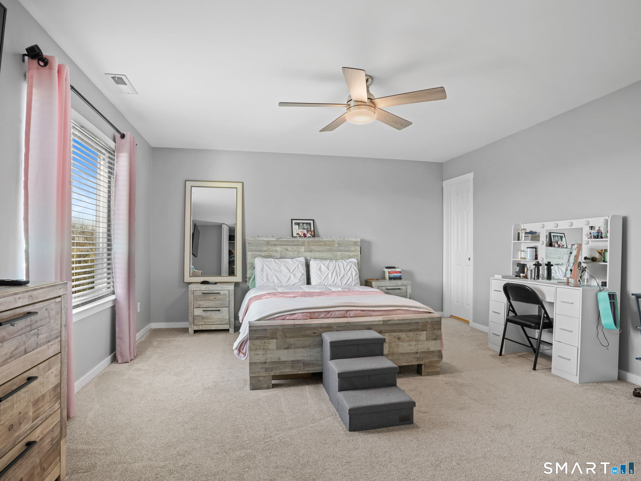 71 Aiken Street, Unit C8 Norwalk, CT 06851 - Photo 11 of 29 a bedroom with a bed and a chandelier