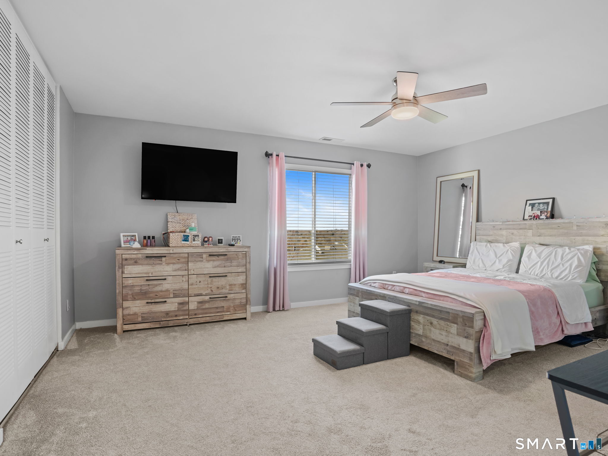 71 Aiken Street, Unit C8 Norwalk, CT 06851 - Photo 12 of 29 a room with a bed and a flat screen tv in a room