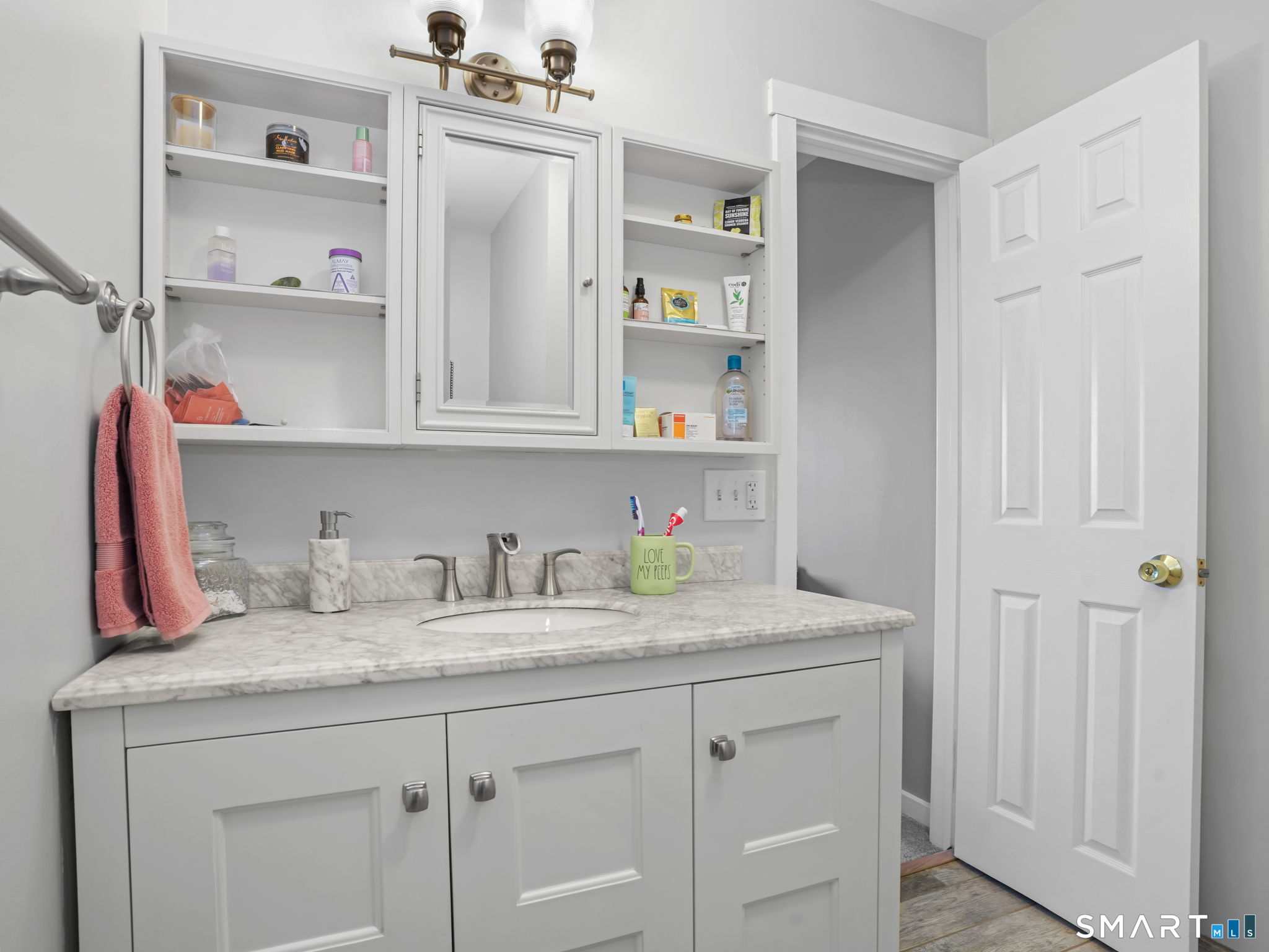 71 Aiken Street, Unit C8 Norwalk, CT 06851 - Photo 14 of 29 a kitchen with white cabinets and wooden floor