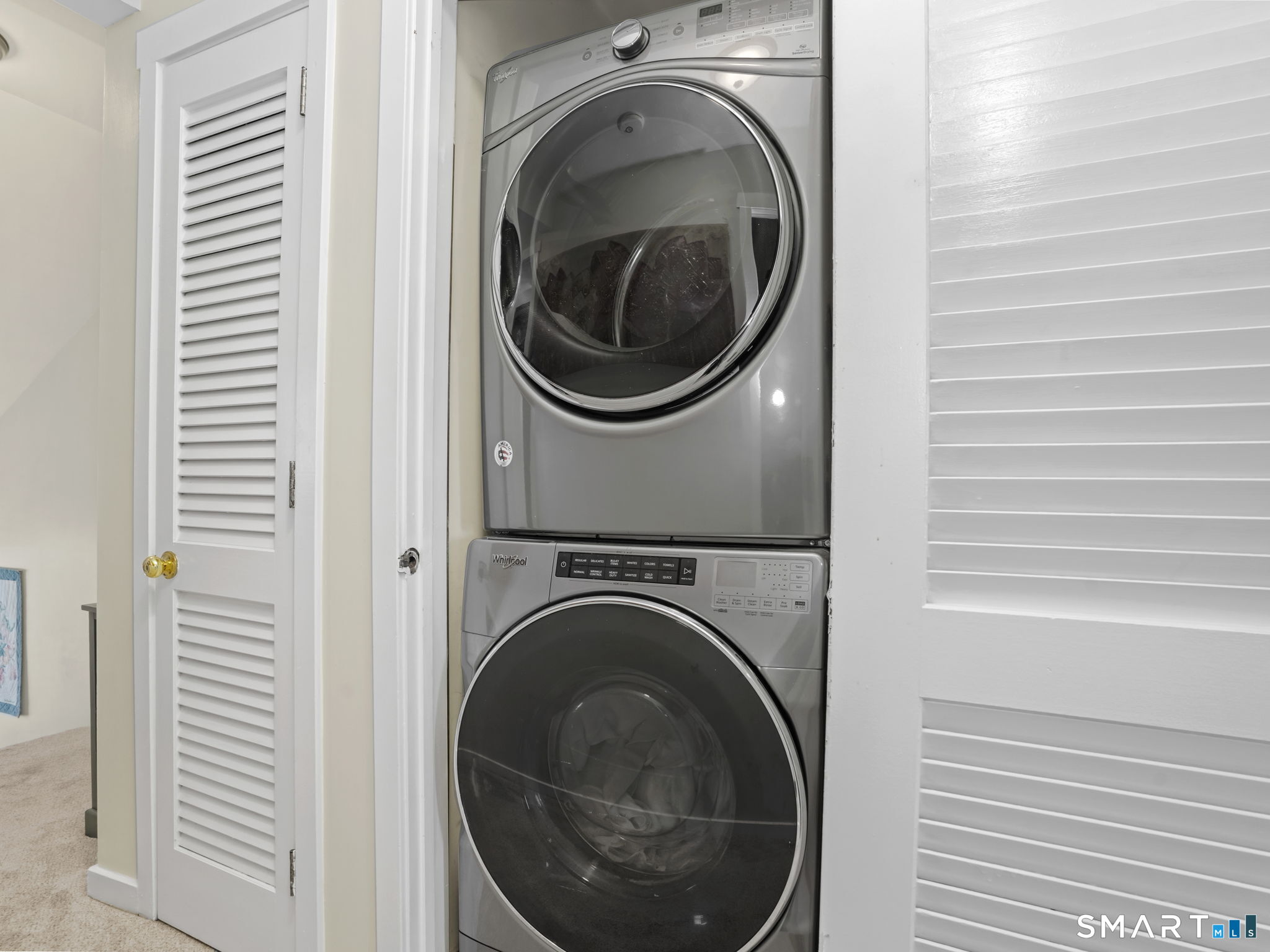 71 Aiken Street, Unit C8 Norwalk, CT 06851 - Photo 21 of 29 a view of a hallway with washer and dryer