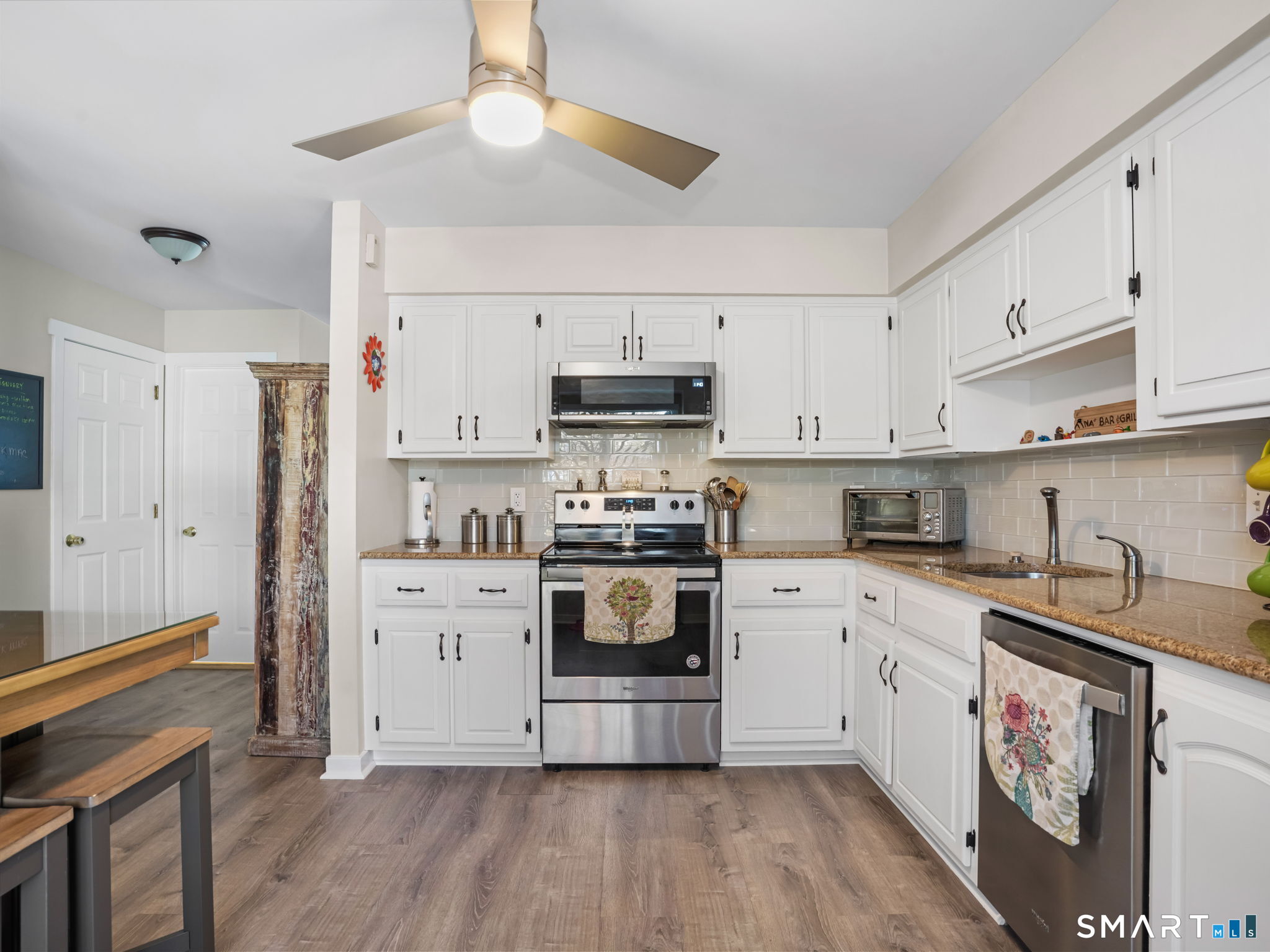 71 Aiken Street, Unit C8 Norwalk, CT 06851 - Photo 3 of 29 a kitchen with stainless steel appliances a stove a sink and a refrigerator
