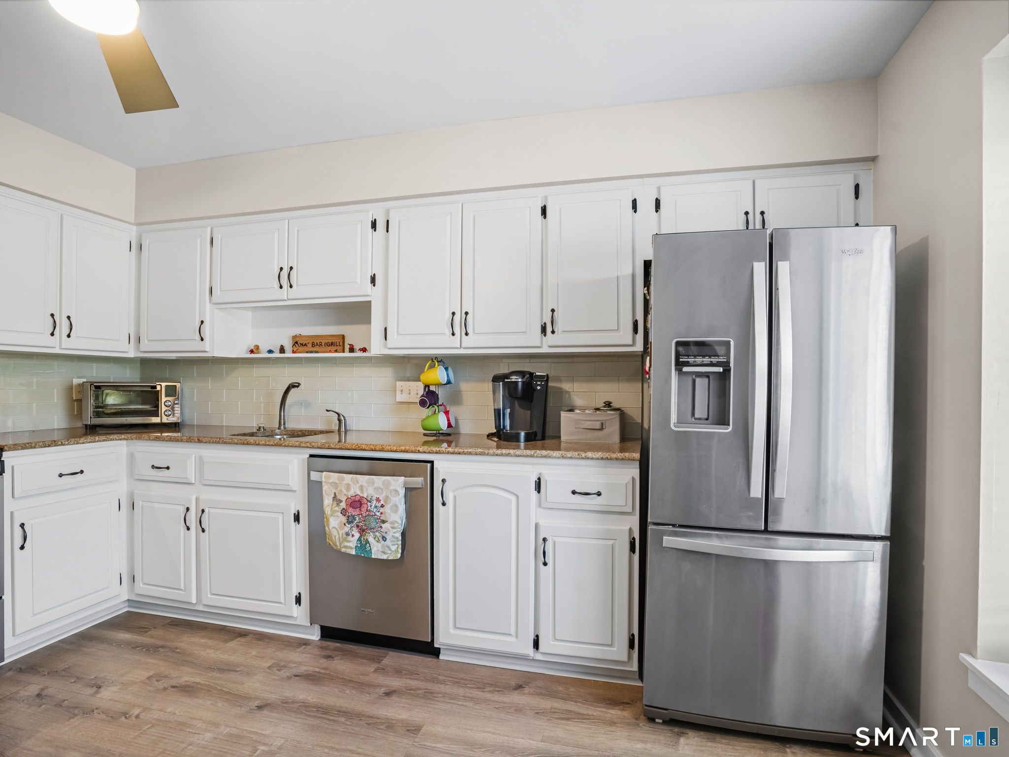 71 Aiken Street, Unit C8 Norwalk, CT 06851 - Photo 4 of 29 a kitchen with stainless steel appliances white cabinets and a refrigerator