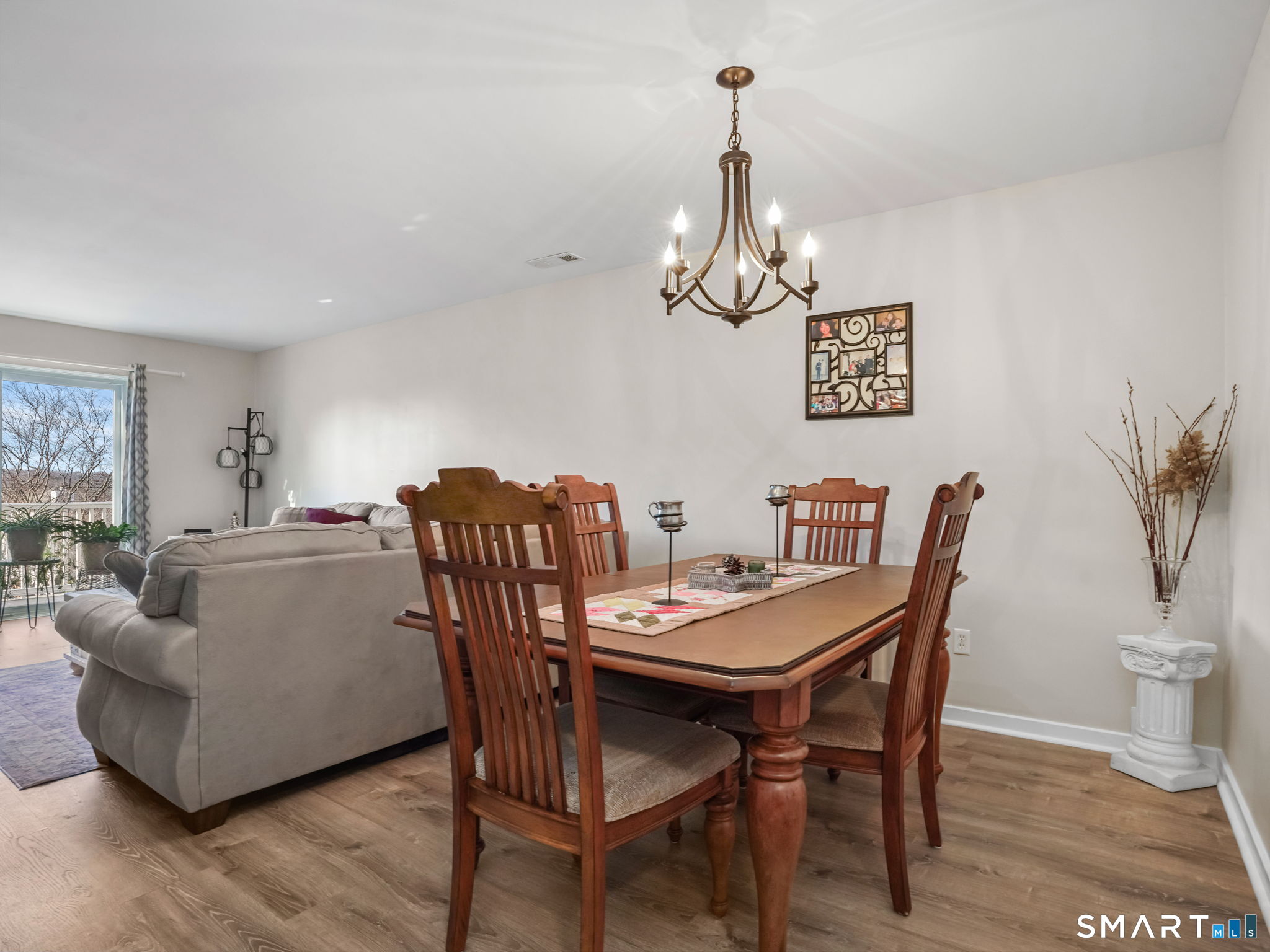 71 Aiken Street, Unit C8 Norwalk, CT 06851 - Photo 9 of 29 a view of a dining room with furniture wooden floor and chandelier
