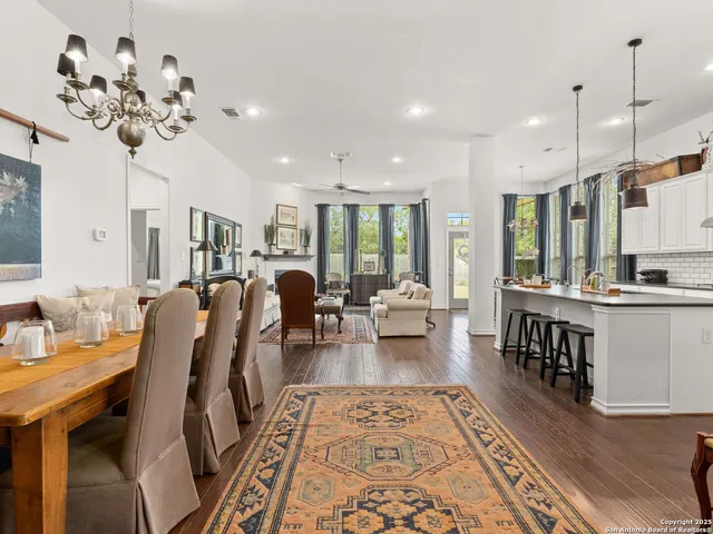 a living room with kitchen island furniture and a chandelier