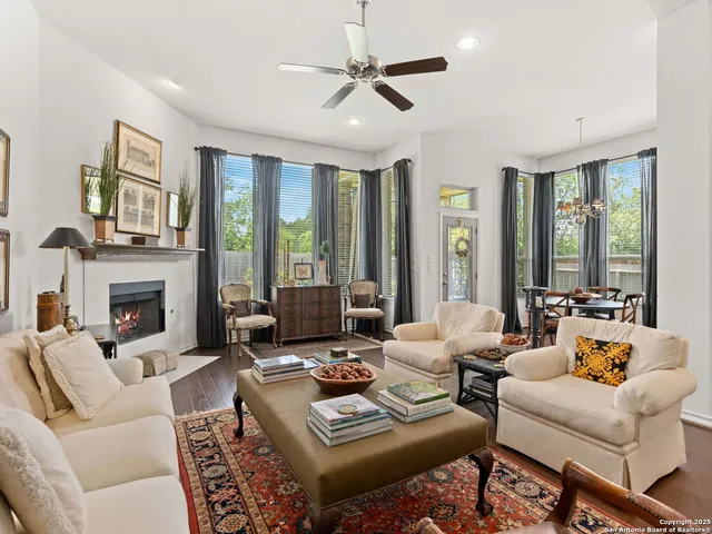 a living room with furniture fireplace and a large window